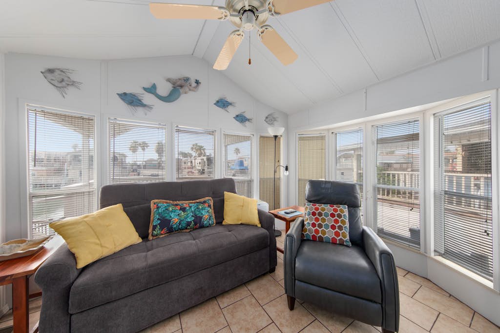 Welcome to Little Breeze, a bright single-level waterfront cottage on a quiet canal in the gated Long Island Village resort near Port Isabel. Sip coffee on the covered deck, take in water views from nearly every window, and settle into a cheerful coastal retreat with a queen bedroom and a living room sleeper sofa. Dive into the resort pools, play the par-3 golf course, or cross the causeway to South Padre Island beaches in minutes. Your easygoing Gulf Coast getaway starts here.