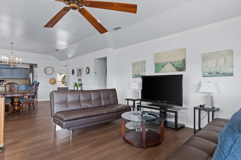 Welcome to 203 Amelia Beach House, a spacious five-bedroom island retreat built for big groups and great times on South Padre Island. Spread out across two living areas and two kitchens, then challenge the crew in the game room with a pool table, ping pong, air hockey, and arcade games. Unwind on the breezy covered decks overlooking the water, with room for up to 16 guests. It is the perfect home base for sun, fishing, and family fun on the Texas Gulf Coast.