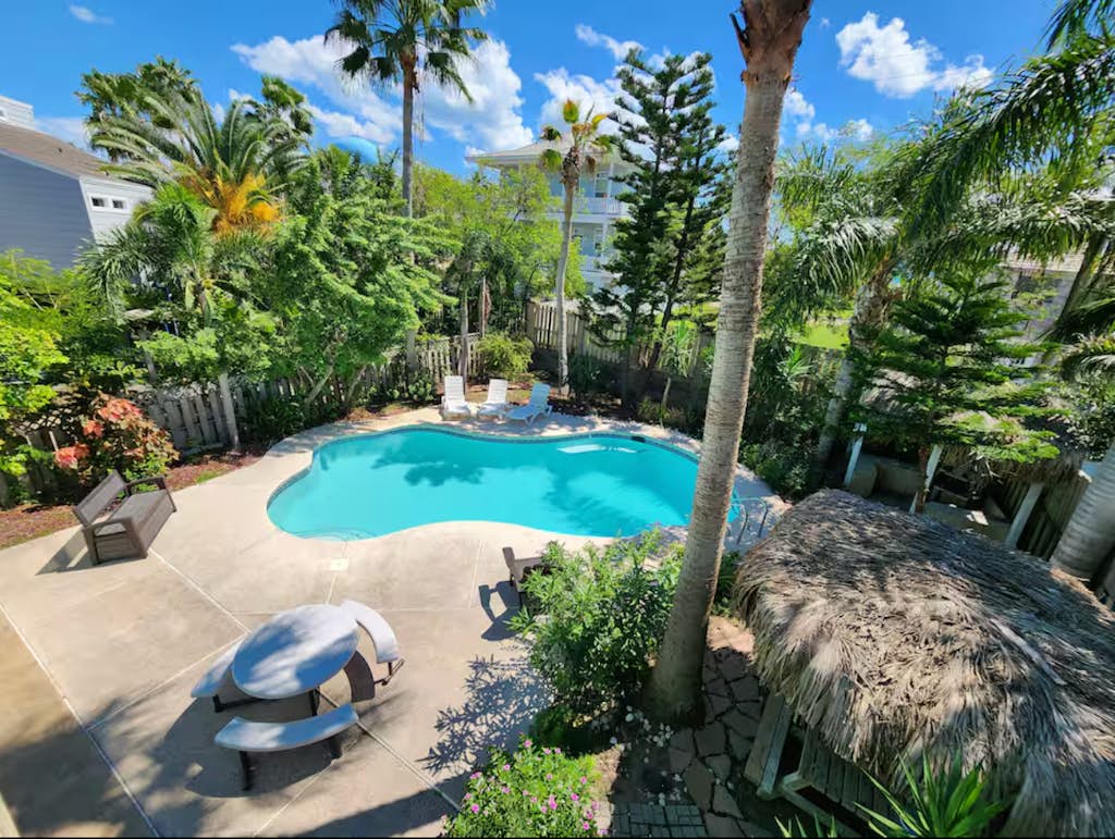 Welcome to Oleander Oasis, a bright two-story island home built for big groups on South Padre Island. Splash in your private pool, relax under the shaded palapa, and gather upstairs in a soaring open living space with a shuffleboard for friendly competition. Five bedrooms and three baths sleep 16, including two king suites and a fun bunk room for the kids. You are a short walk from the Gulf beach and minutes from Isla Blanca Park. Your island home base is ready.