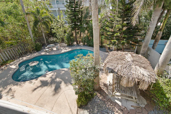 Welcome to Oleander Oasis, a bright two-story island home built for big groups on South Padre Island. Splash in your private pool, relax under the shaded palapa, and gather upstairs in a soaring open living space with a shuffleboard for friendly competition. Five bedrooms and three baths sleep 16, including two king suites and a fun bunk room for the kids. You are a short walk from the Gulf beach and minutes from Isla Blanca Park. Your island home base is ready.