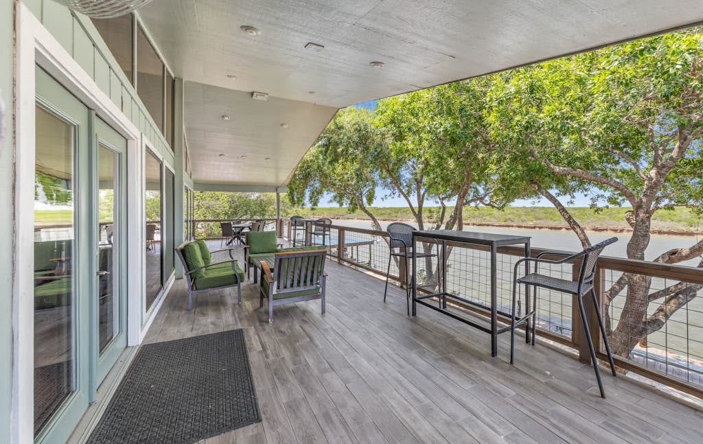 Welcome to the Upper Level of Casa Arroyo Sporting Lodge, the prime spot on the water in Arroyo City. Five bedrooms and four baths sleep up to 14, with an elevator for easy access and a wide covered balcony overlooking the arroyo and wildlife refuge. Watch boats and barges drift by, cast from the lighted pier, gather in the open great room and bar, and cook in the full kitchen. You are minutes from world-class bay fishing and the Laguna Atascosa refuge.