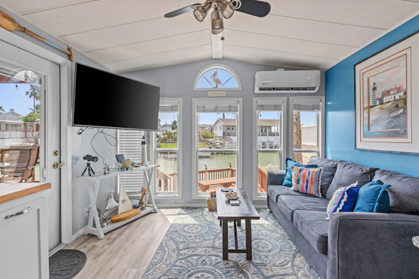 Welcome to Calm Clam, a bright two-bedroom cottage tucked along a quiet canal in the gated Long Island Village resort. Start your mornings with coffee on the waterfront deck, cast a line from your dock, then fill your days with resort pools, par-3 golf, and tennis. South Padre Island's beaches and dining sit a short drive over the bridge. With a restful king bedroom, a comfortable queen room, and breezy coastal interiors, Calm Clam is your easy Gulf Coast escape.