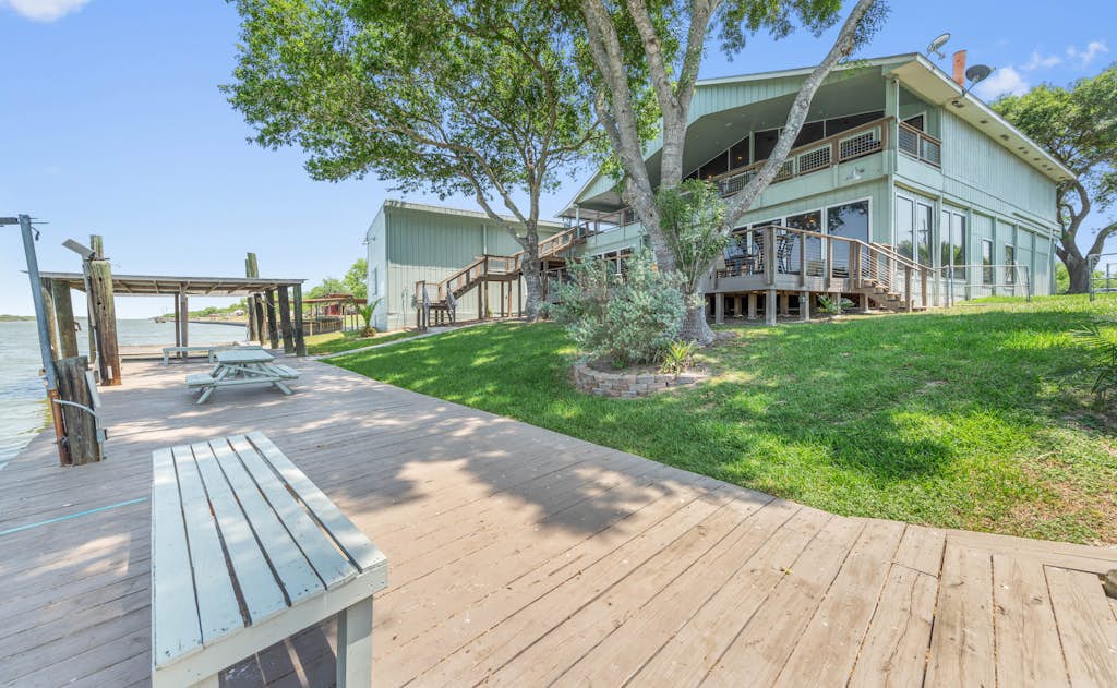 Welcome to the First Floor of Casa Arroyo Sporting Lodge, a spacious waterfront retreat in Arroyo City. Four bedrooms sleep up to nine, with a brand-new kitchen, a big open living and game room with a pool table, and a wide deck with a BBQ overlooking the water. Step out to the lighted pier for fishing day or night, watch the boats drift by, and settle in where the Arroyo Colorado meets the Lower Laguna Madre. World-class bay fishing is right at your door.