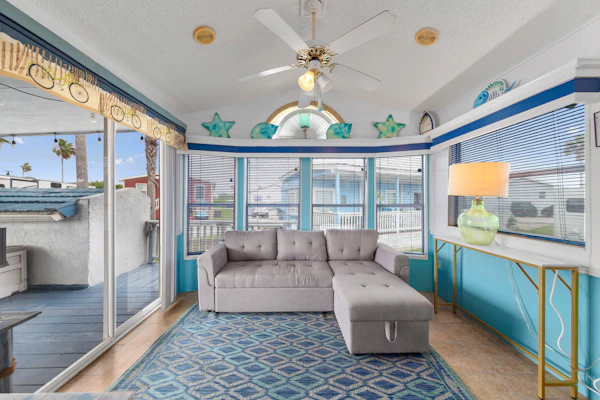 Welcome to Blue Paradise, a bright and breezy one-bedroom cottage tucked inside the gated Long Island Village resort in Port Isabel. Sink into the sunroom-style living room wrapped in windows, cook in the cheerful coastal kitchen, and unwind on your covered deck. Your stay unlocks the resort's pools, hot tubs, golf, tennis, and more, with South Padre Island's beaches just ten minutes across the causeway. Sleeps four, and your dog is welcome too.