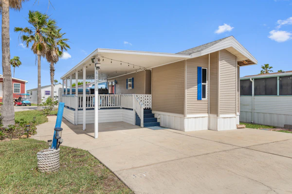 Welcome to Blue Paradise, a bright and breezy one-bedroom cottage tucked inside the gated Long Island Village resort in Port Isabel. Sink into the sunroom-style living room wrapped in windows, cook in the cheerful coastal kitchen, and unwind on your covered deck. Your stay unlocks the resort's pools, hot tubs, golf, tennis, and more, with South Padre Island's beaches just ten minutes across the causeway. Sleeps four, and your dog is welcome too.