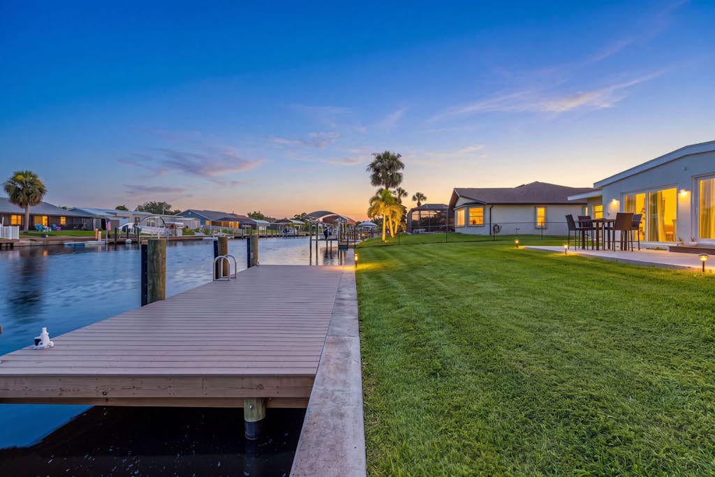 Discover the ultimate waterfront sanctuary in this charming three bedroom home located in the heart of Port Charlotte. This bright and airy holiday home features a private backyard with scenic water views, providing the perfect backdrop for your morning coffee or evening relaxation. The property is fully stocked with modern amenities including a complete kitchen, laundry facilities, and family friendly essentials to ensure a stress free stay. Guests will love the proximity to local water sports, scenic cycling paths, and shopping destinations. Experience the perfect blend of coastal tranquility and convenient access to Florida attractions in this inviting single level residence.