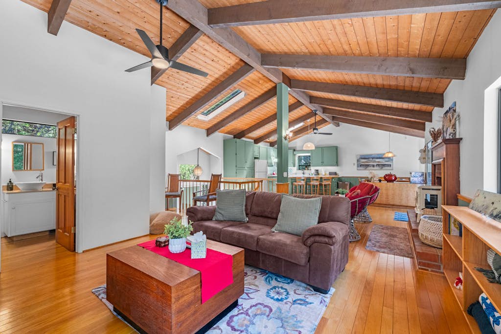 Wake up in the redwoods above Gualala on the Mendocino coast. This multi-level 3BR/3BA forest home sleeps 8: rally around the game room's convertible pool/ping-pong table, soak in the freestanding tub, and grill on two levels of deck under string lights. An attached ADU suite adds its own bedroom, sitting room, bath, and private entrance. WiFi, washer/dryer, and an EV charger for guests - beaches and downtown Gualala are minutes down the hill.