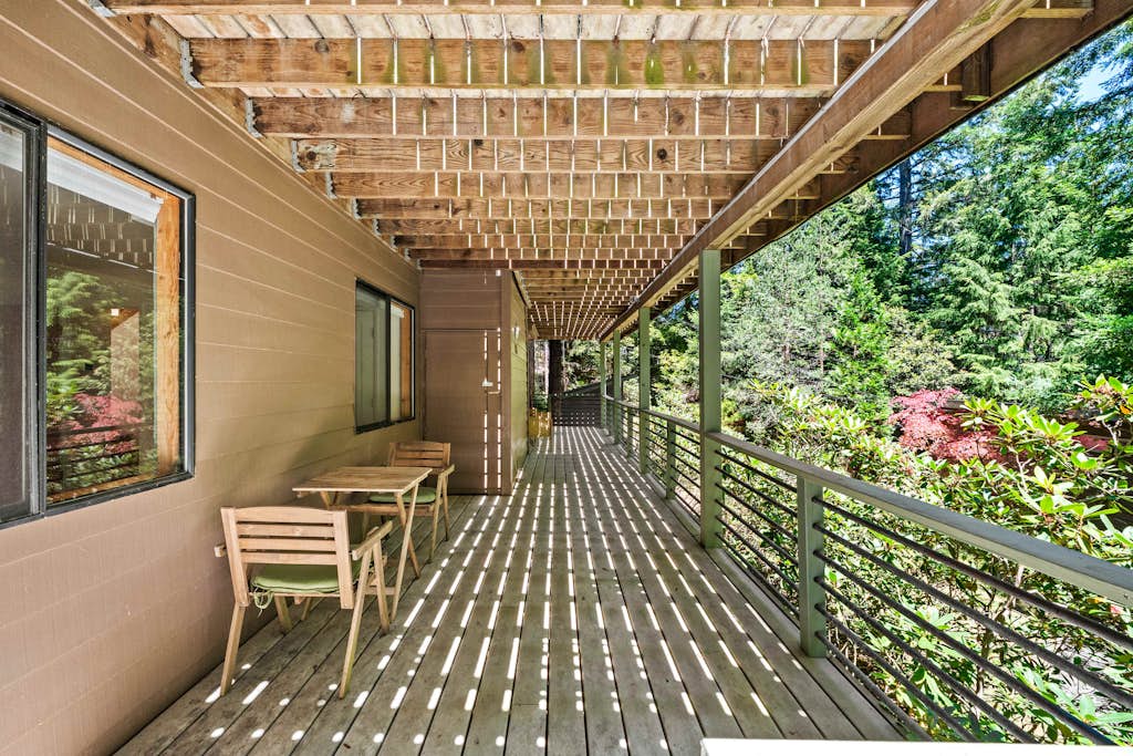 Wake up in the redwoods above Gualala on the Mendocino coast. This multi-level 3BR/3BA forest home sleeps 8: rally around the game room's convertible pool/ping-pong table, soak in the freestanding tub, and grill on two levels of deck under string lights. An attached ADU suite adds its own bedroom, sitting room, bath, and private entrance. WiFi, washer/dryer, and an EV charger for guests - beaches and downtown Gualala are minutes down the hill.