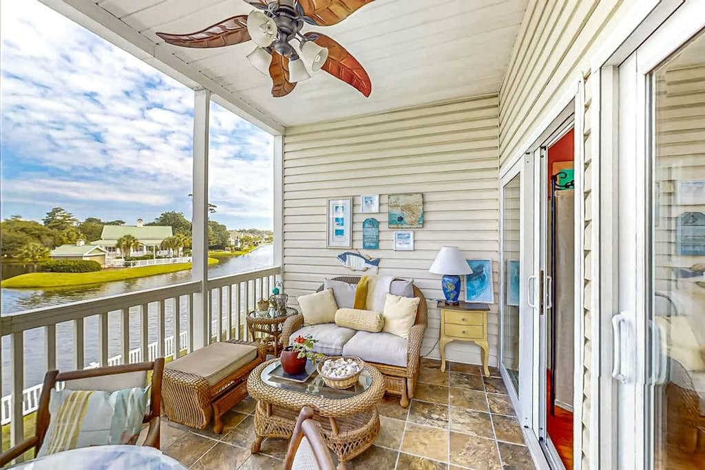 Bright and spacious condo with resort amenities, water views, balcony, & AC