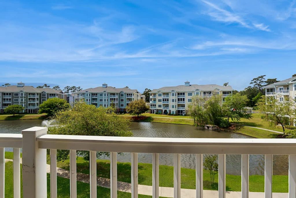 Lakefront condo near beach with water views, pool, golf, balcony, clubhouse, AC
