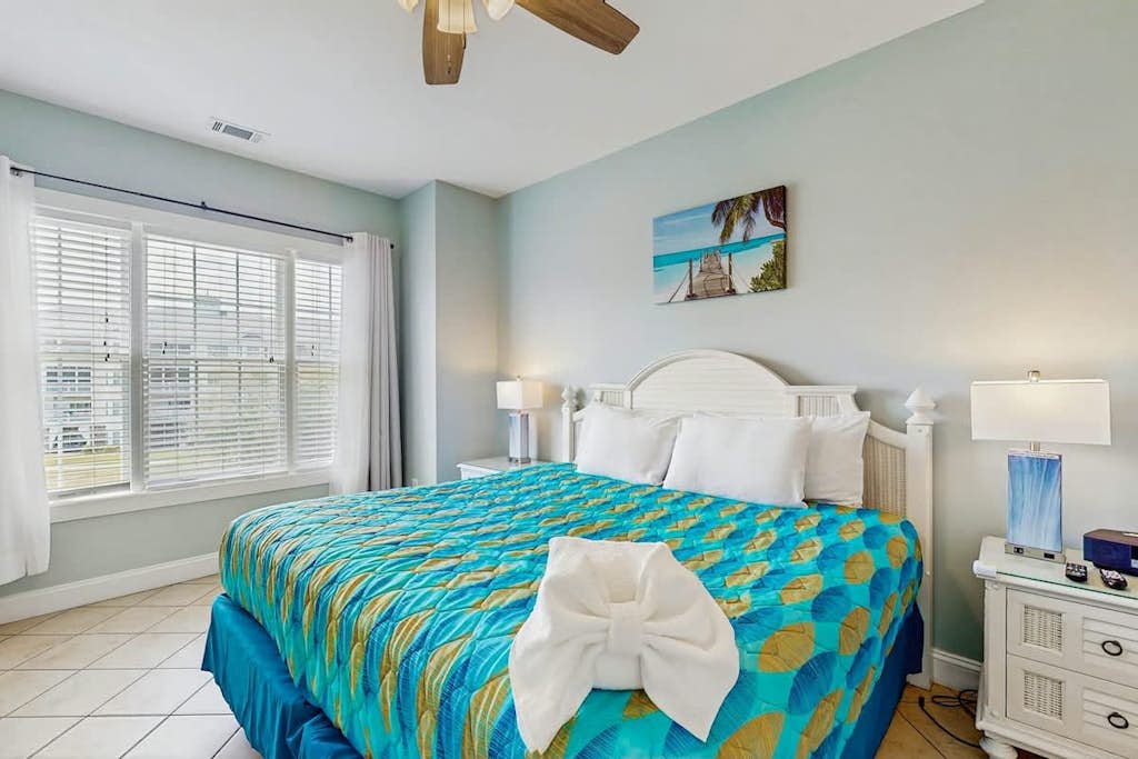 Lakefront condo near beach with water views, pool, golf, balcony, clubhouse, AC
