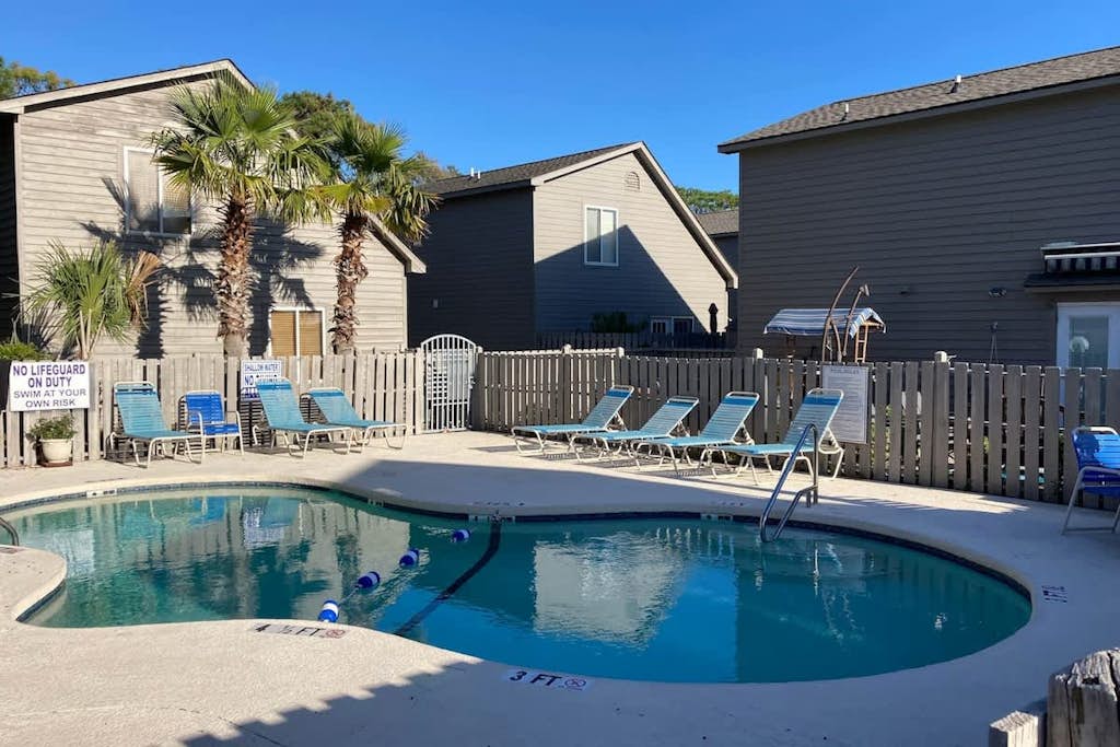 Inviting house 4 blocks from beach with on-site pool, private patio, deck, & W/D