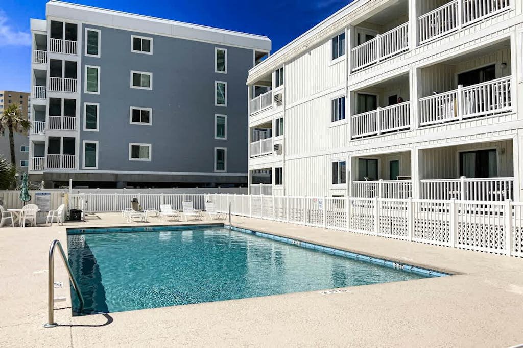 Oceanfront condo with balcony, beach view, pool access, & central AC