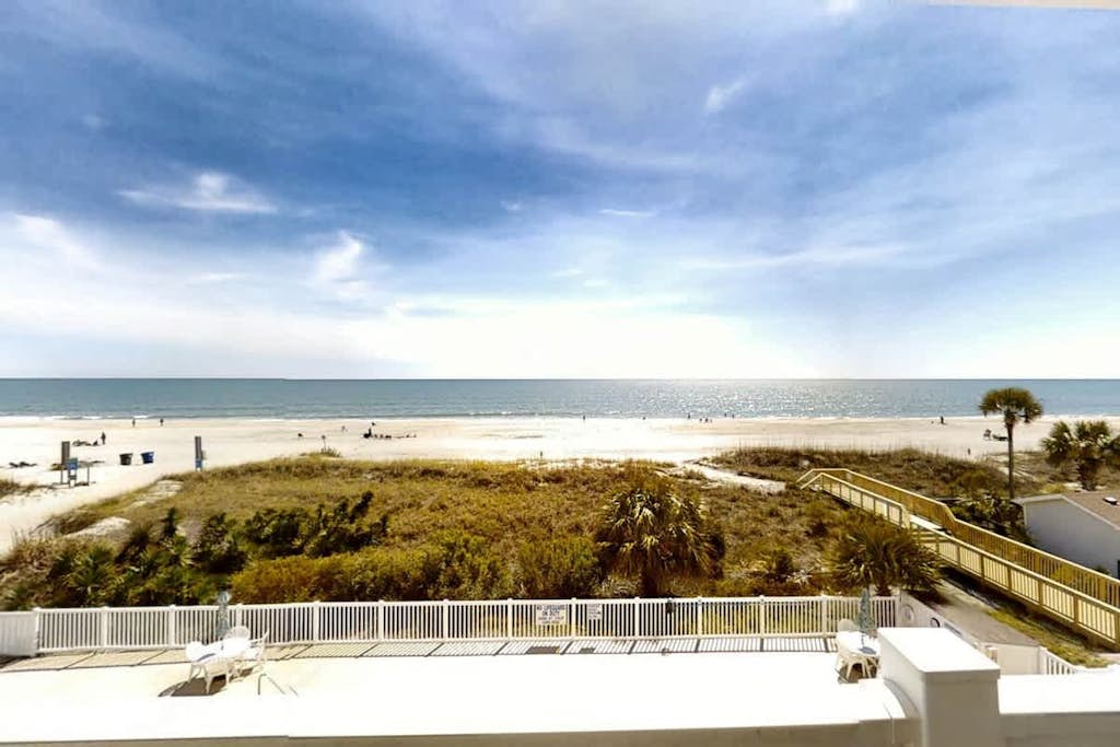 Oceanfront condo with balcony, beach view, pool access, & central AC