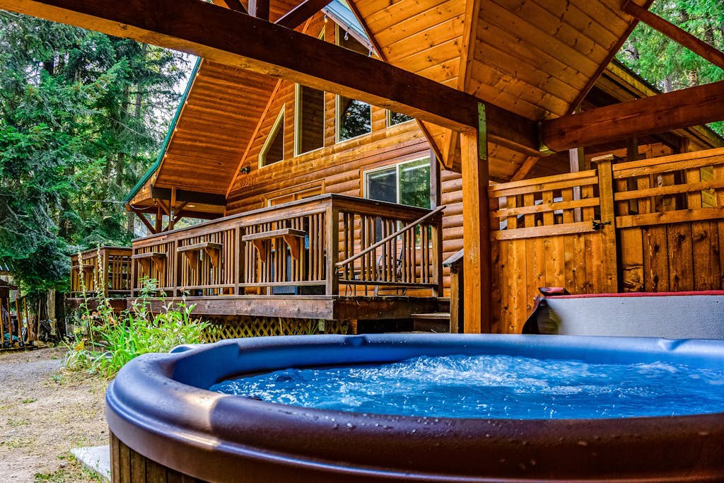Elegant, secluded home with a wood deck, gas grill, & private hot tub