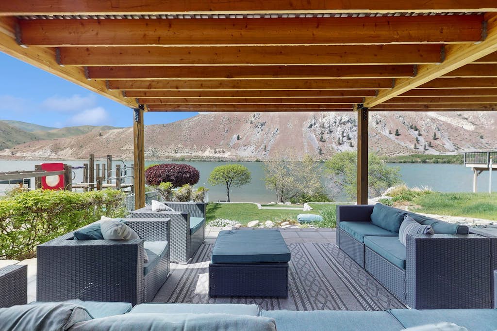 Dog-friendly waterfront home with pool, tennis courts, & large lawn