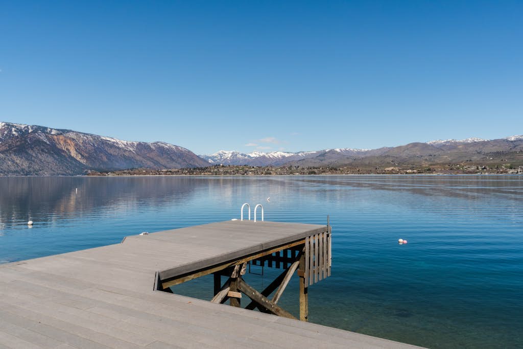 Modern lakefront home with private dock, amazing sunset views, & chef's kitchen