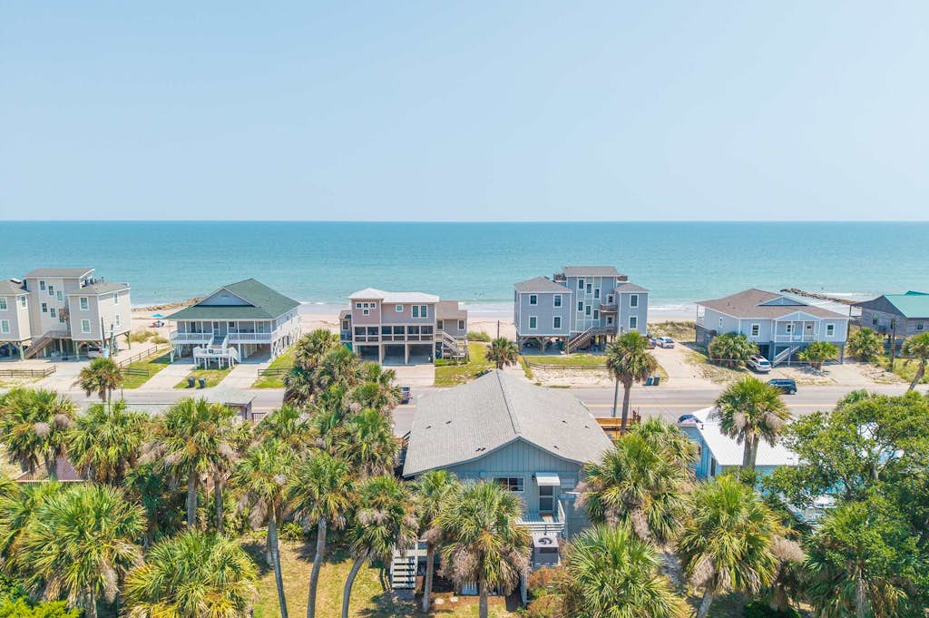 Welcome to the "Edistoneyan" Edisto Beach — Ocean Views, just steps from the sand!

4BR, 2BA | Sleeps 12

Welcome to "The Edistoneyan" your ocean-view Edisto Island getaway. Located directly across the street from the beach, this home puts the sand and surf right at your doorstep, with stunning ocean views to boot. This home is in the most ideal location on Edisto Beach, closet to restaurants, shops, grocery and recreational park activities. 

The large relaxing screened-in porch is made for slow mornings and easy evenings, complete with a dining table and rocking chairs where you can watch the world go by. Step outside to the sun deck with built-in seating—ideal for soaking up some rays or unwinding after a day at the beach. A grill is on hand for classic beach-night cookouts.

Inside, the home is thoughtfully laid out with two mirrored bedroom wings on either side of the main living space, so everyone has room to spread out. The open living, dining, and kitchen area sits right in the middle, keeping the whole group connected.

The home offers four bedrooms and two full bathrooms. On one side, you'll find a King bedroom with ocean views, along with a Queen bedroom featuring a twin bunk (2 twin beds), and a full bathroom conveniently located in the hall. On the opposite side, there's a second King bedroom with ocean views, plus another Queen bedroom with twin bunks, and a second full bathroom.

With two king bedrooms offering ocean views, this home is perfect for multiple couples or families looking to wake up to the water.

The home has a spacious open front porch off of the screened porch and an outdoor shower on the back patio. There is a laundry room downstairs with some beach gear and plenty of room for lounging and playing outdoor games. 

House Rules:

Quiet hours: 10:00 PM – 8:00 AM
Pet friendly — $150 per pet
Minimum guest age: 25