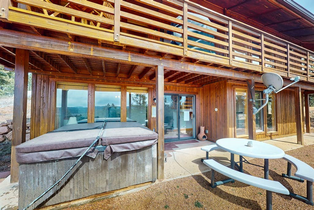 Secluded mountain-view home with expansive deck, hot tub, deck, & grill