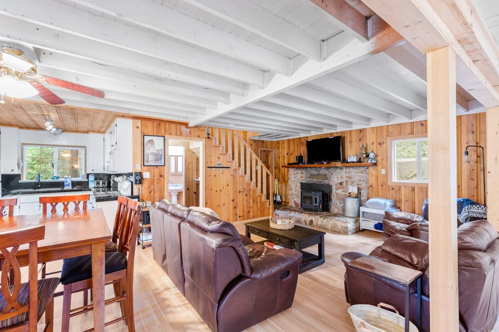 Cozy Blue Lake Springs cabin w/ big trees, decks, game room, and private W/D