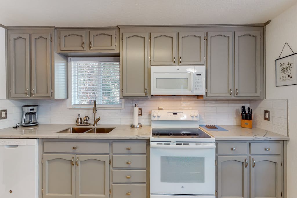 Lovely home away w/ wraparound deck, gas grill, full kitchen, & stylish decor