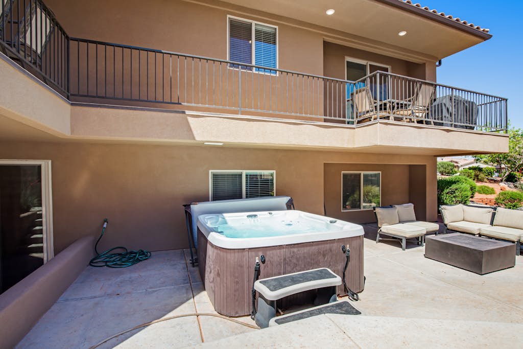 Stunning home with private hot tub, shared pool, fitness room, deck, & firepit