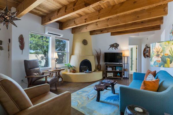 Casa de Colores is a charming high-desert retreat on over an acre just outside Santa Fe, with exposed wood beams, mountain views, and beautiful New Mexico sunrises and sunsets. Enjoy coffee on the shaded patio, comfortable interiors with AC, and a second living area. Sleeps 4 with 2 bedrooms, 2 baths, and is just 20 minutes from the Santa Fe Plaza. Traveling with a dog? The fully fenced yard even has a playful window at dog height.