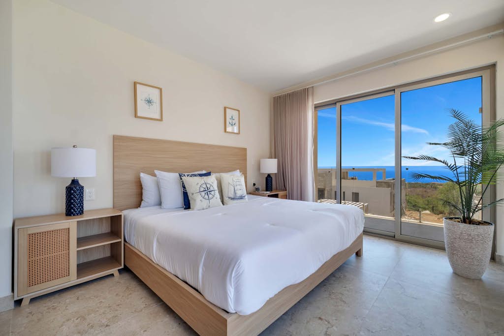 Enjoy this two-bedroom condo, thoughtfully designed with amazing ocean views
• One King bed, and two single beds
• Community Pool with ocean views and sun loungers
• Private balcony with outdoor furniture
• Business center
• Fitness center
• Fifteen minutes driving to Cabo San Lucas downtown
• Convenience stores nearby
• Pickle Ball courts nearby (not included)
• Fully equipped kitchen, smart TV, and AC
• 24/7 security and controlled access