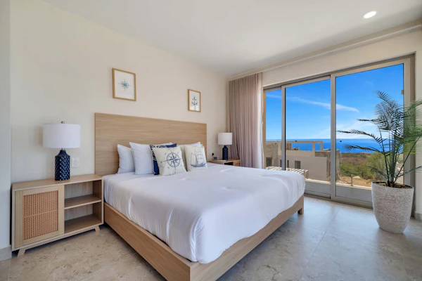 Enjoy this two-bedroom condo, thoughtfully designed with amazing ocean views
• One King bed, and two single beds
• Community Pool with ocean views and sun loungers
• Private balcony with outdoor furniture
• Business center
• Fitness center
• Fifteen minutes driving to Cabo San Lucas downtown
• Convenience stores nearby
• Pickle Ball courts nearby (not included)
• Fully equipped kitchen, smart TV, and AC
• 24/7 security and controlled access