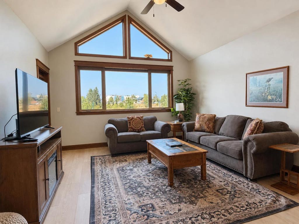 Tucked inside the walkable Village at Riverstone, this vaulted-ceiling one-bedroom is your basecamp for Coeur d'Alene — steps from restaurants, a movie theater, and the river trail, with secure underground parking and elevator access to make every arrival effortless.