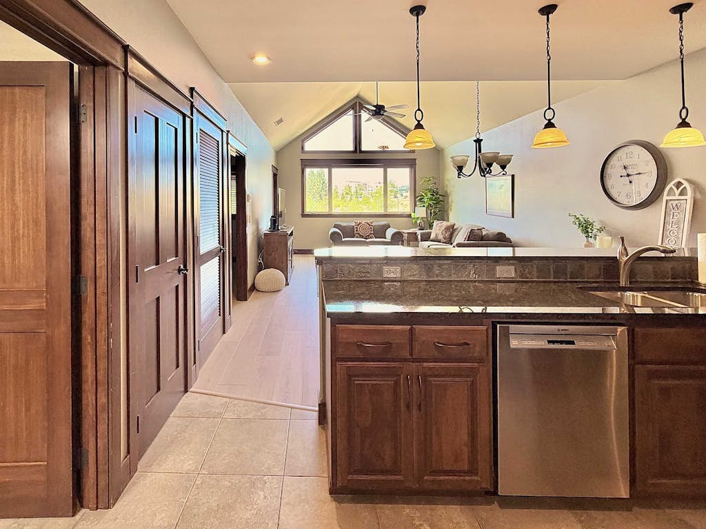 Tucked inside the walkable Village at Riverstone, this vaulted-ceiling one-bedroom is your basecamp for Coeur d'Alene — steps from restaurants, a movie theater, and the river trail, with secure underground parking and elevator access to make every arrival effortless.
